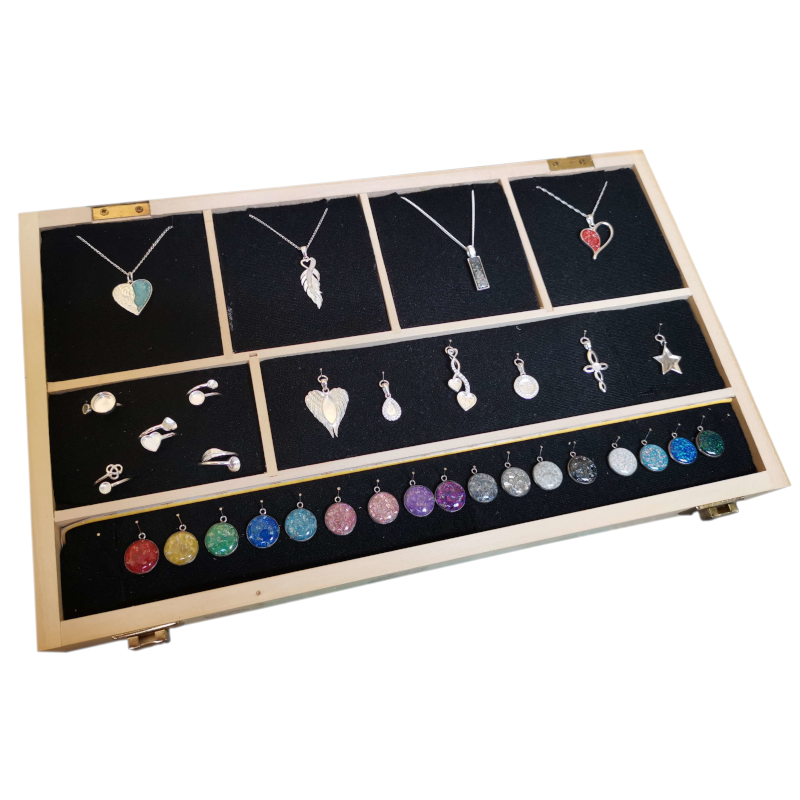 A beautifully crafted presentation box for KW Eternal Collection, showcasing elegant resin jewelry with a selection of colours, designs, chains, and pendants.